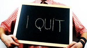 Employee holding a sign reading “I Quit”