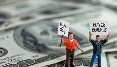 Figures on money holding “Higher Pay” and “Better Benefits” signs